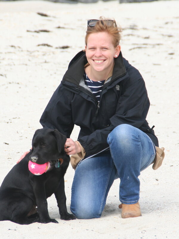 Kate, founder of Produced Near-By, with her dog on the beach